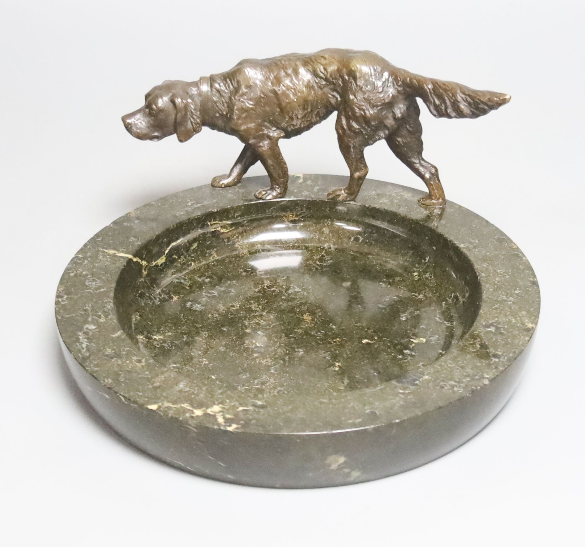 An early 20th century bronze 'setter' serpentine trinket dish, 25cm